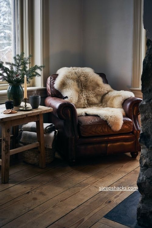 Faux shearling Christmas throw with leather trim on dark leather chair 