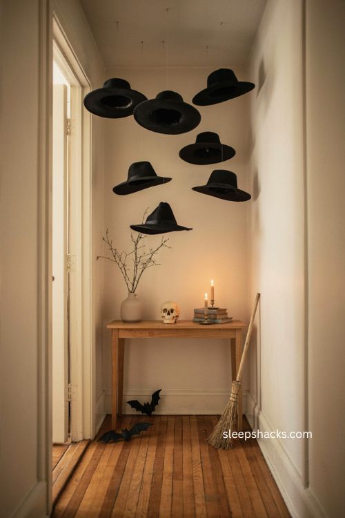 Floating witch hats above narrow Halloween entry table with skull broom and bats