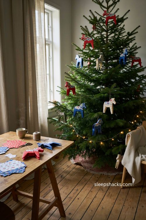Folded dala horse ornaments with colorful scandinavian paper designs and traditional christmas tree charm 