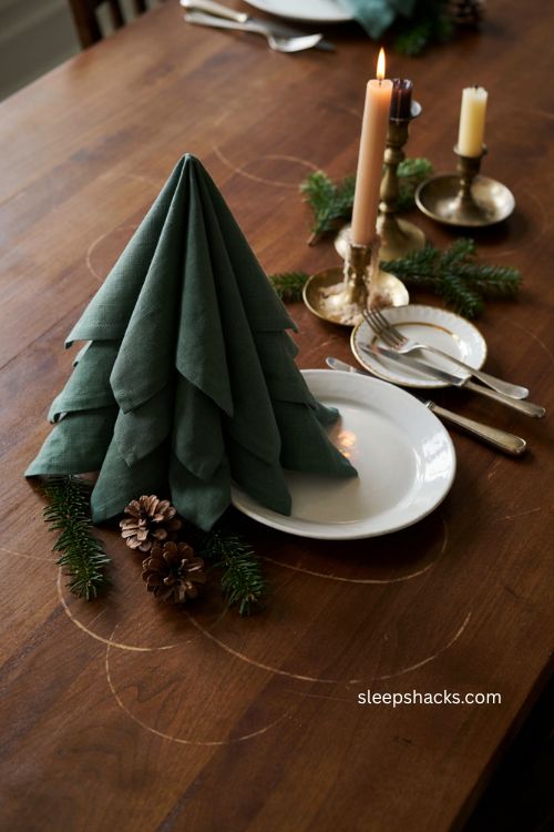 Forest green Christmas tree napkin folding for a classic holiday table 