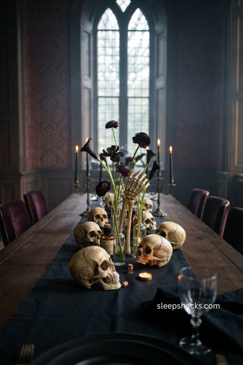 Gothic skeleton hand test tube vases and dark flowers for a halloween table 