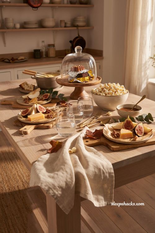 Grab and go Thanksgiving snack table with chocolates popcorn cheese fondue and cake dome
