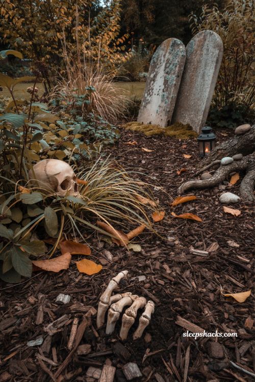 Halloween garden ideas with skeleton hand buried in soil and spooky tombstones