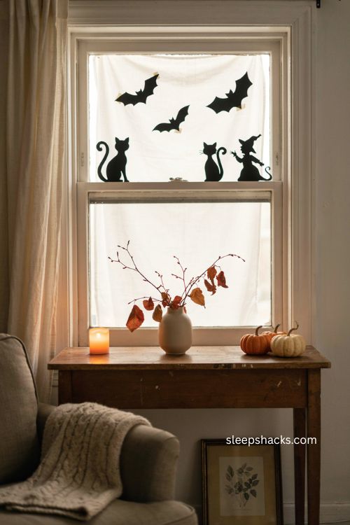 Halloween window silhouettes with bats cats and witch decor 