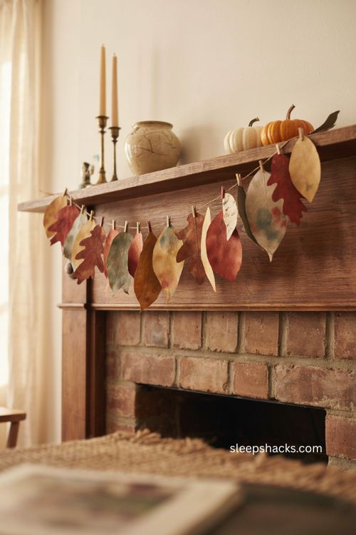 Handmade paper leaf garland in warm fall colors on a mantle 
