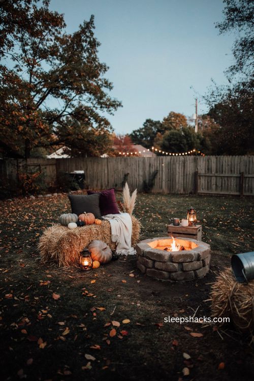 Hay bale and pumpkin lounge corner for cozy backyard Halloween parties 