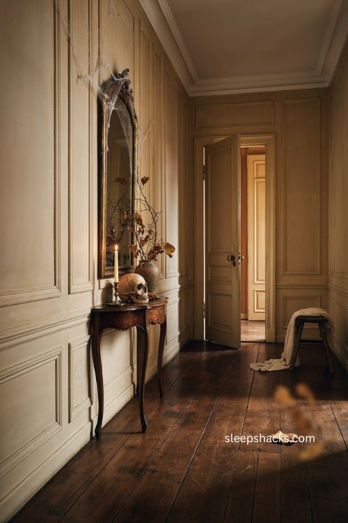 Heritage hallway Halloween decor with subtle spiderwebs skull candle and traditional Gothic elegance