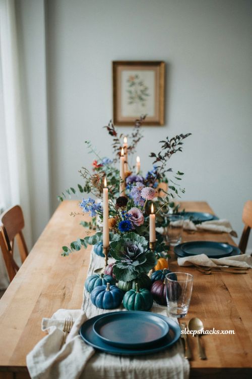 Jewel tone Thanksgiving tablescape with blue green purple pumpkins and flowers