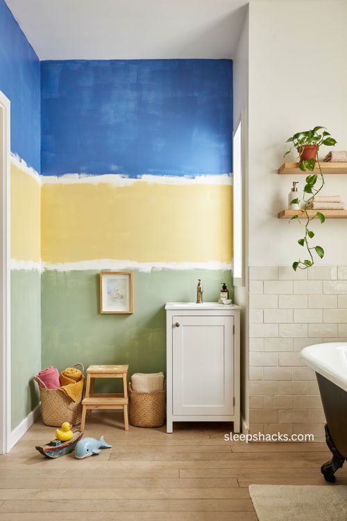 Kids bathroom accent wall ideas with playful blue yellow and green color blocking