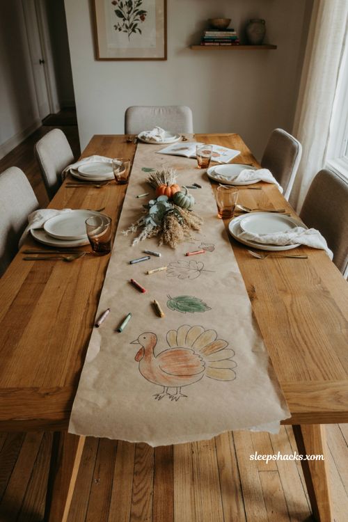 Kids coloring Thanksgiving table runner with butcher paper crayons fall leaves pumpkins and farmhouse decor 