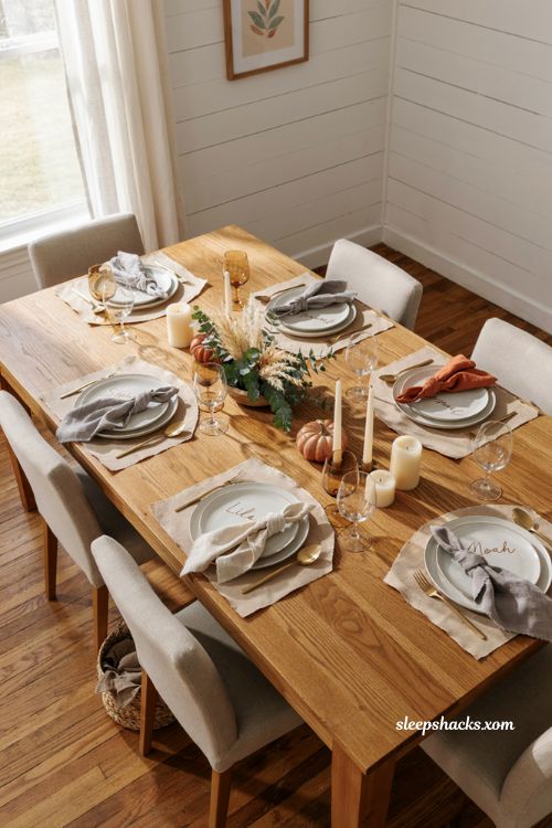 Kraft paper charger Thanksgiving table with handwritten place cards ceramic plates pumpkins and rustic decor 
