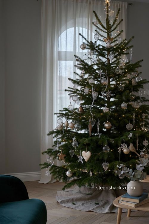 Layered crystal shapes christmas tree with stars hearts teardrops diamonds icicles and sparkling round ornaments 