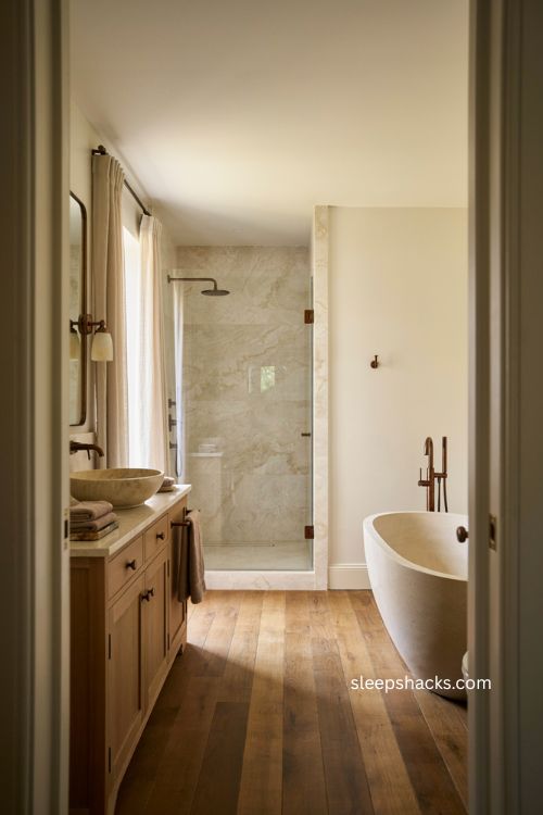 Luxury bathroom with aged bronze fixtures marble vanity and warm sophisticated accents 