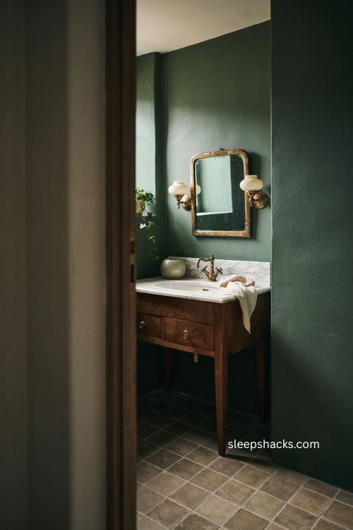 Marble vanity moody bathroom with dark walls natural veining brass fixtures and timeless luxury 
