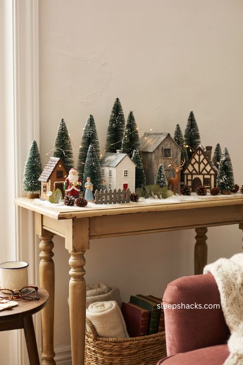 Mini Christmas village on a console table with faux snow and vintage holiday houses 