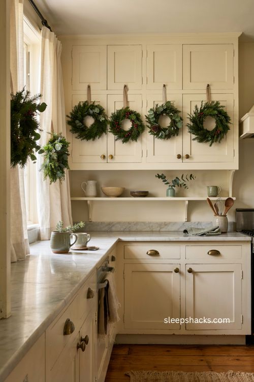 Mini Christmas wreaths hanging on kitchen cabinet doors 