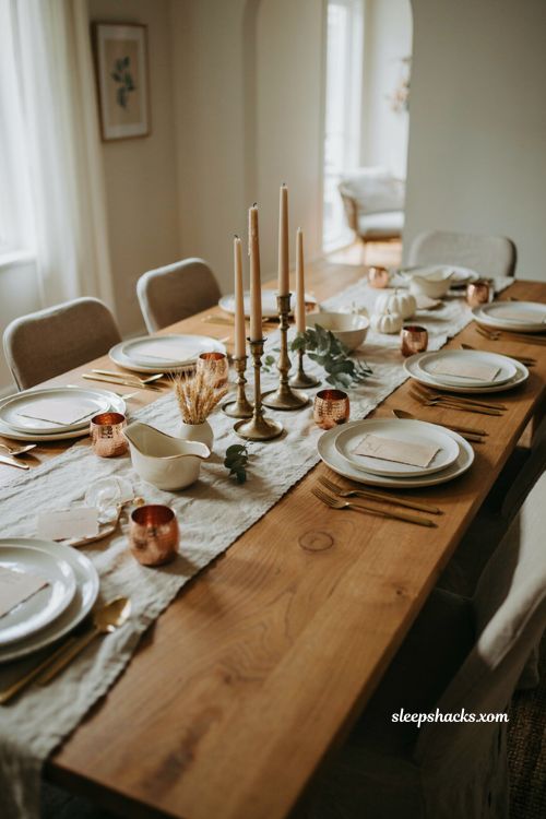 Mixed metal Thanksgiving table with gold flatware brass candlesticks and copper accents
