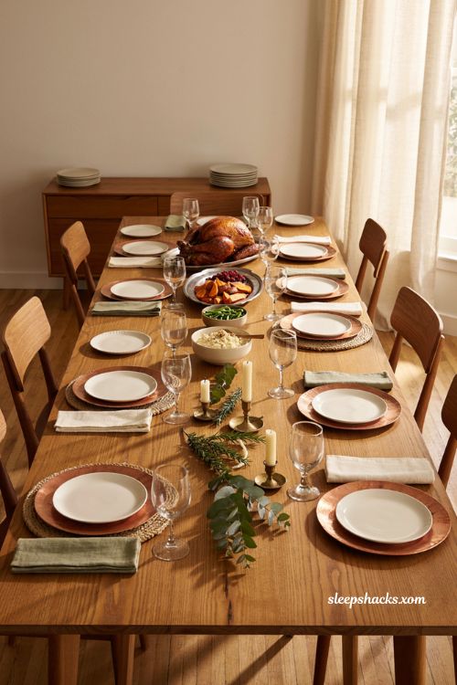 Mixed metals and textures Thanksgiving table with copper chargers silver platters and woven placemats 