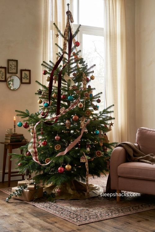 Multiple ribbons on a Christmas tree with velvet plaid striped and floral ribbon layers 