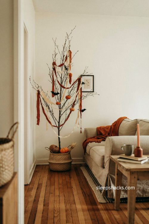 Muted rust and cream paper garland wrapped around a cozy halloween tree 