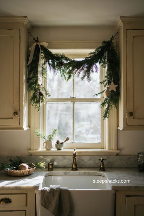 Natural Christmas garland draped across farmhouse kitchen window 
