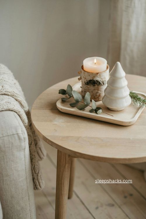Natural nordic christmas end table decor with wood white candle and greenery 