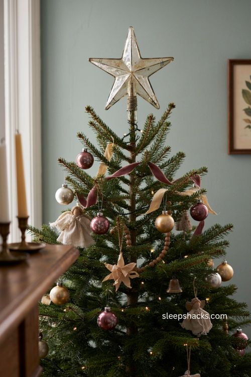 Nostalgic Christmas tree with vintage glass star topper faded angel and antique holiday decor 