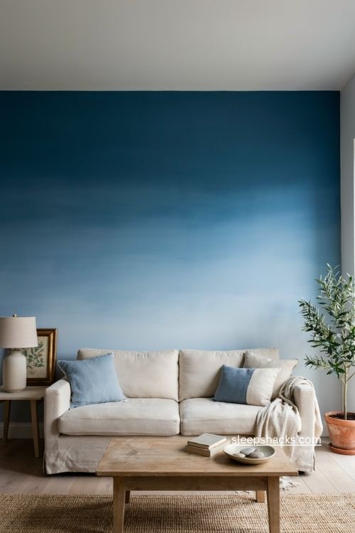 Ombré blue feature wall living room with soft coastal decor and neutral furniture 