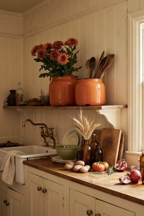 Orange enamelware pots for cozy vintage farmhouse Halloween kitchen decor 