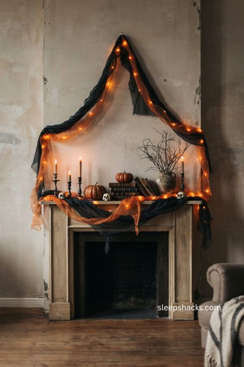 Orange string lights wrapped in torn black cheesecloth Halloween fireplace mantel decor