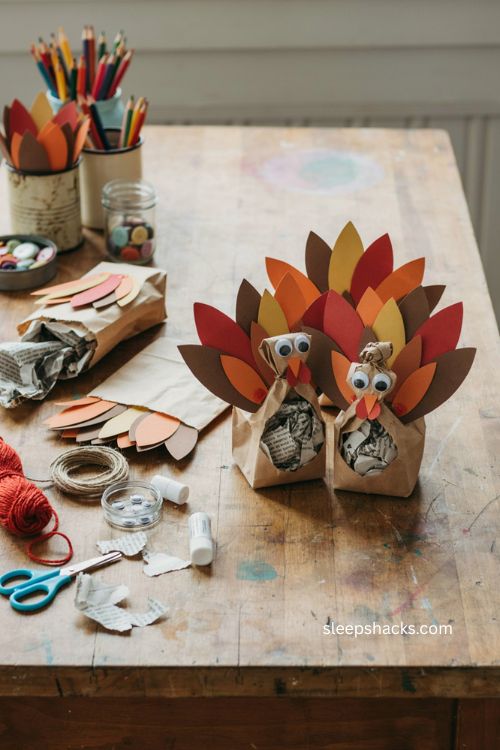 Paper bag turkey puppet craft for toddlers with colorful Thanksgiving feathers 