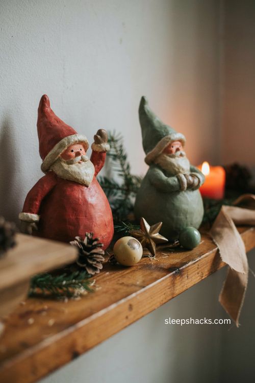 Paper mache santa figures with sculpted paper texture vintage holiday colors and cozy christmas shelf decor 