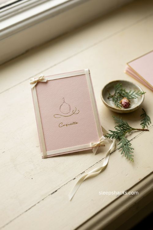 Pastel pink Christmas card with cream sage bows and gold details 
