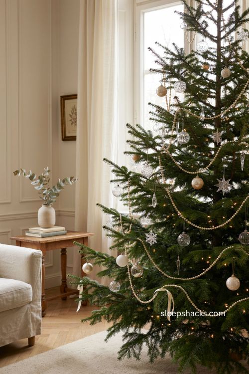 Pearl and crystal christmas tree with loose pearl garlands sparkling ornaments warm white lights and elegant winter decor 