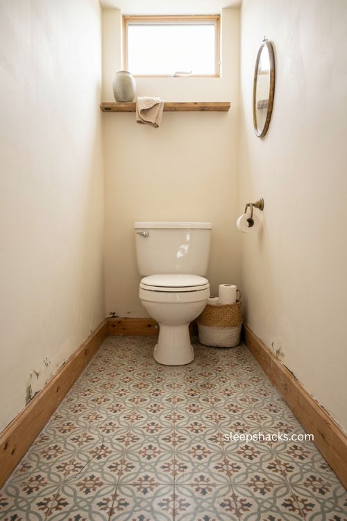 Peel and stick floor tiles in a cozy water closet with vintage patterned flooring