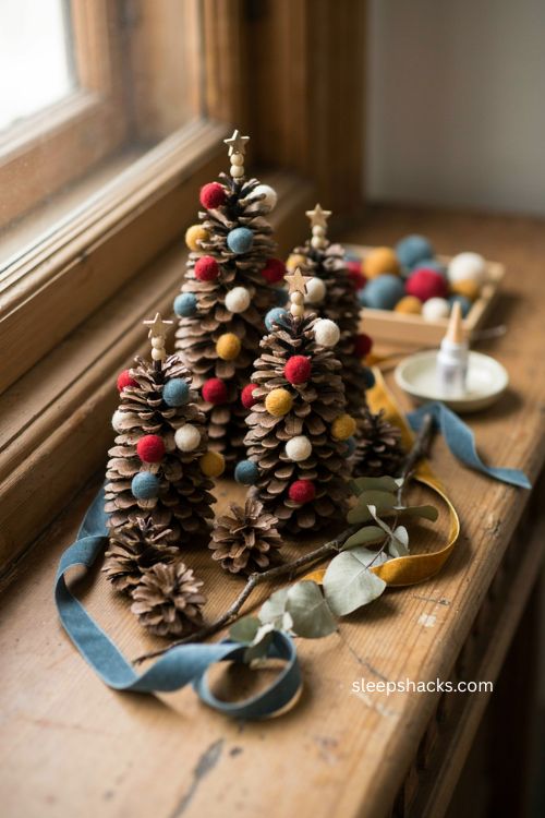Pinecone and pom pom Christmas tree craft for toddlers with colorful handmade ornaments 
