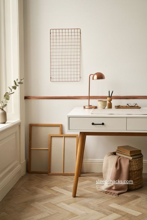 Pink office decor with rose gold desk lamp and neutral workspace accents 