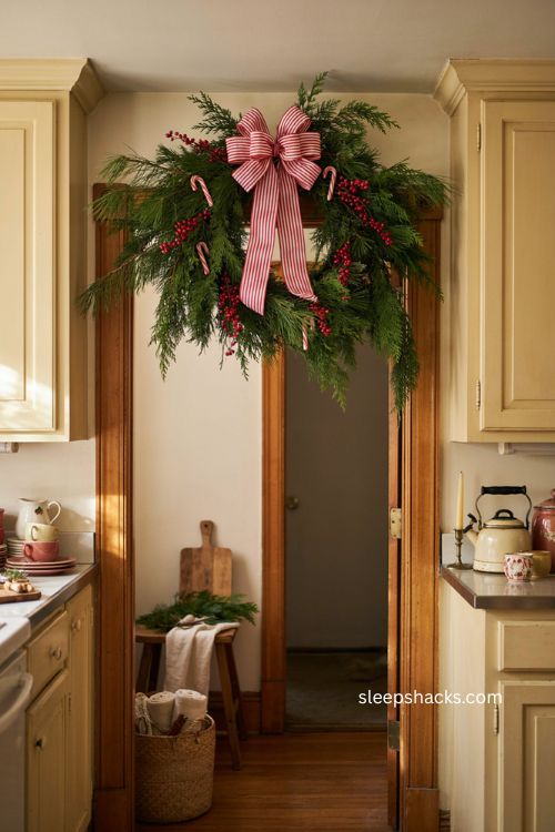 Playful candy cane Christmas swag with red berries striped ribbon and evergreen