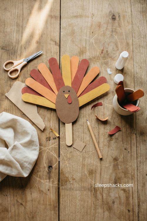 Popsicle stick turkey puppet craft with paper feathers for Thanksgiving 
