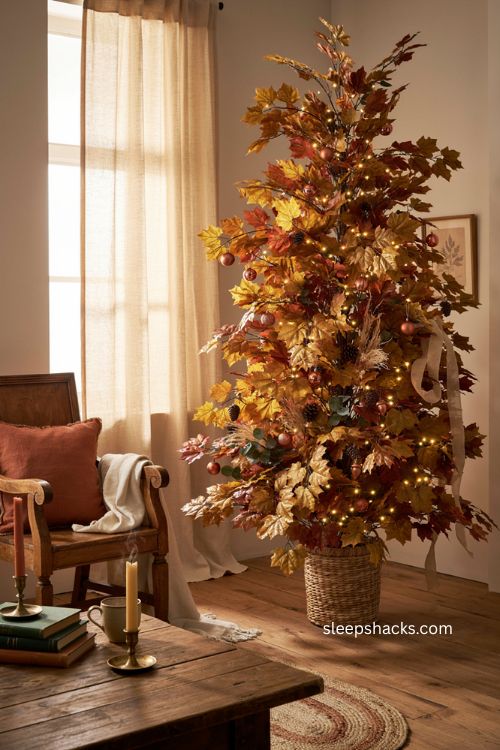 Pre lit maple leaf fall Christmas tree with warm lights and rustic decor