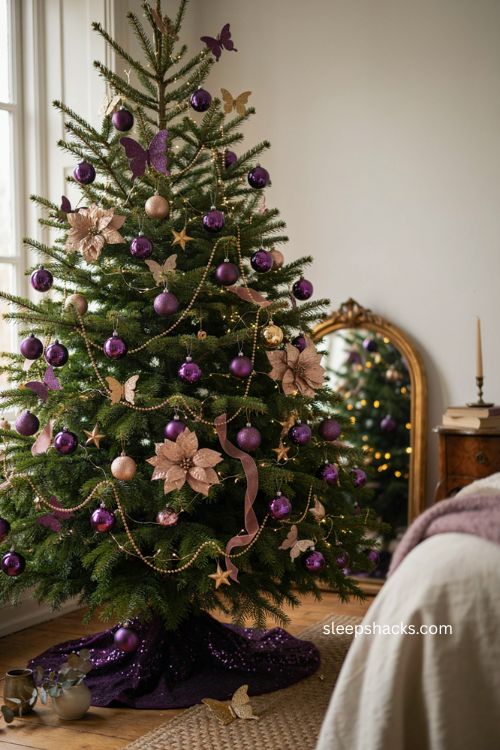 Purple and gold Christmas tree with glitter butterfly ornaments and romantic nature inspired decor 