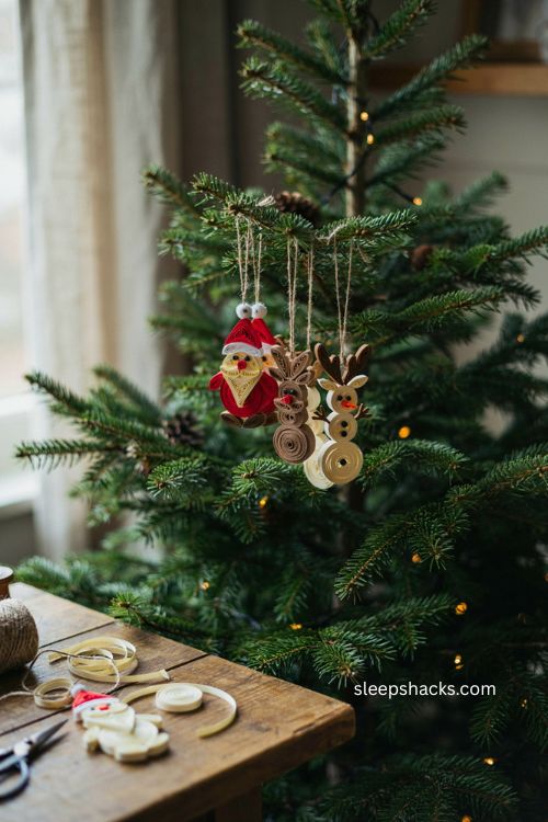 Quilled character ornaments with handmade santa reindeer and snowman paper figures on a cozy christmas tree 