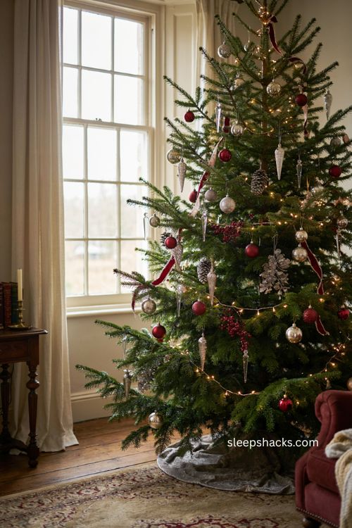 Red and silver Christmas tree with mercury glass finial ornaments 