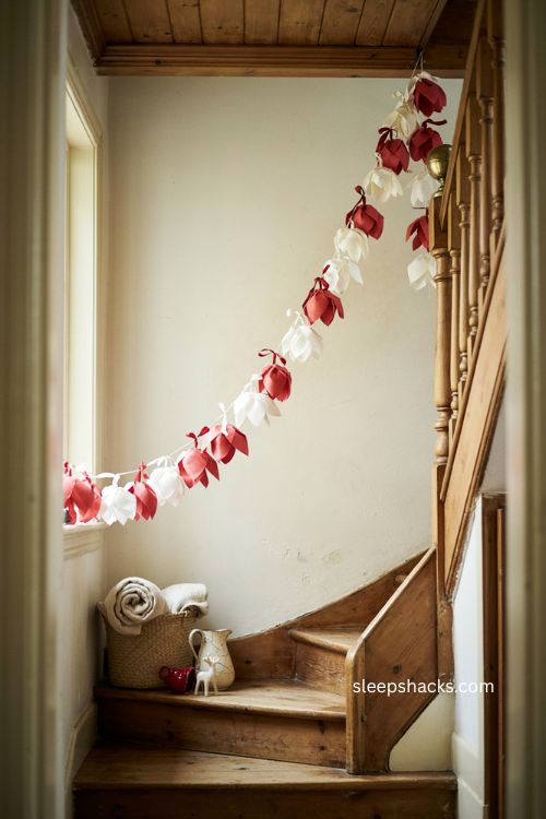 Red and white paper bell Christmas garland on staircase