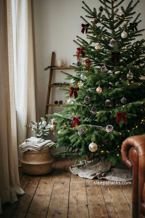 Red velvet bows with pinecones on a rustic Christmas tree 
