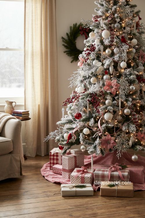 Red white and silver Christmas presents under a flocked tree with gingham and plaid ribbons 