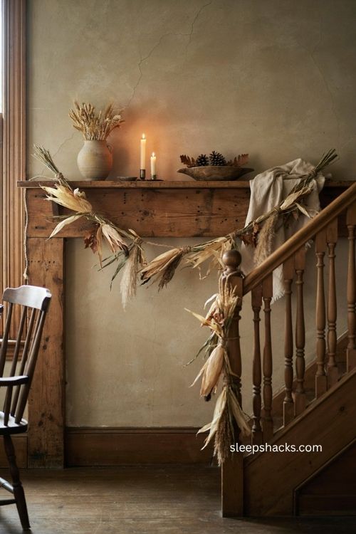 Rustic fall cornhusk garland with dried grasses sisal rope and raffia on farmhouse mantel 