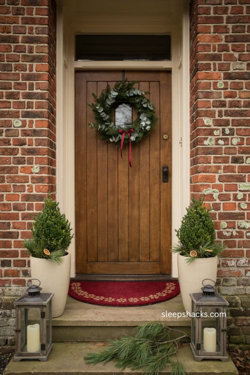Semi circle Christmas doormat with symmetrical wreath and cozy narrow entryway decor 