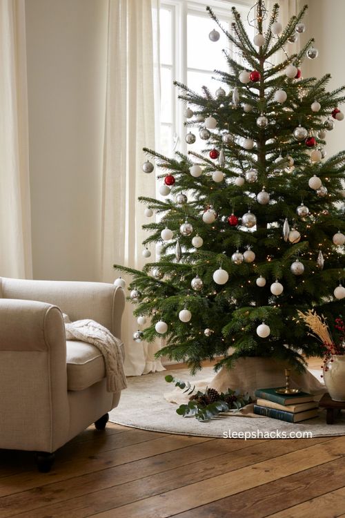 Silver and white Christmas ball ornaments creating a sparkling elegant holiday tree 