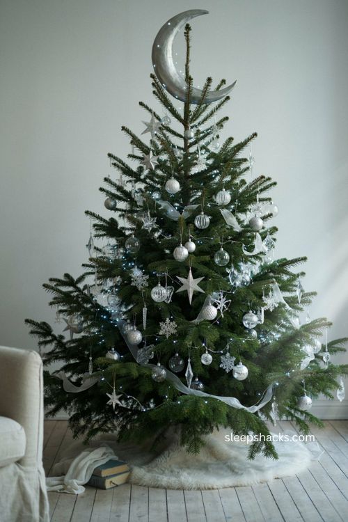 Silver celestial Christmas tree with moon stars snowflakes and crystal ornaments